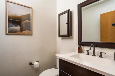 a bathroom with a sink and a toilet and a mirror at Stay in Evergreen - Denver Mountain Escape in Evergreen