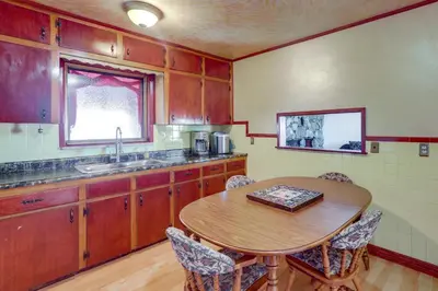 a kitchen with a wooden table and a sink at 5 Mi to Dtwn Denver Pet-Friendly Home with Patio in Denver