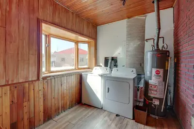 a small kitchen with a refrigerator and a window at 5 Mi to Dtwn Denver Pet-Friendly Home with Patio in Denver