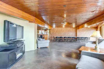 a living room with a flat screen tv and chairs at 5 Mi to Dtwn Denver Pet-Friendly Home with Patio in Denver