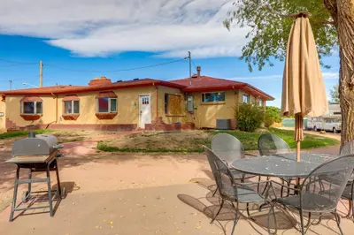 a table and chairs with a grill and an umbrella at 5 Mi to Dtwn Denver Pet-Friendly Home with Patio in Denver