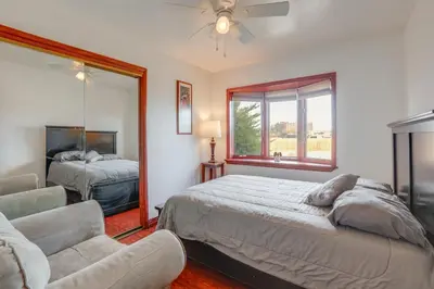a bedroom with a bed and a couch and a mirror at 5 Mi to Dtwn Denver Pet-Friendly Home with Patio in Denver