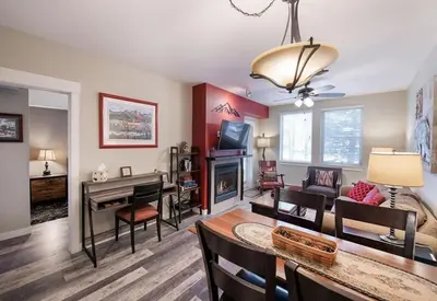 a living room with a table and a dining room at Premium Unit 4373- Fraser Crossing Founders Pointe condo in Winter Park