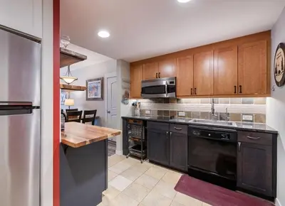 a kitchen with wooden cabinets and a stainless steel appliance at Premium Unit 4373- Fraser Crossing Founders Pointe condo in Winter Park