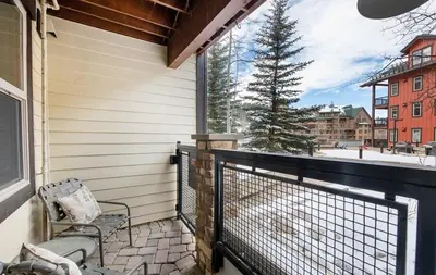 a balcony with a chair and a tree at Premium Unit 4373- Fraser Crossing Founders Pointe condo in Winter Park