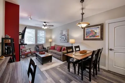 a living room with a table and a couch at Premium Unit 4373- Fraser Crossing Founders Pointe condo in Winter Park
