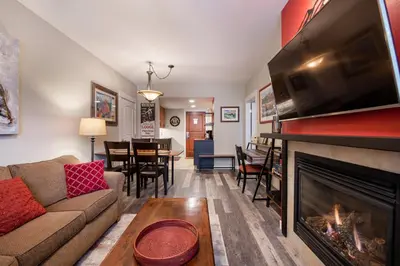 a living room with a fireplace and a tv at Premium Unit 4373- Fraser Crossing Founders Pointe condo in Winter Park