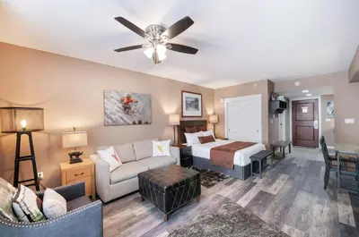 a hotel room with a bed and a couch at Premium Unit 4371- Fraser Crossing Founders Pointe condo in Winter Park
