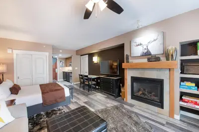 a hotel room with a bed and a fireplace at Premium Unit 4371- Fraser Crossing Founders Pointe condo in Winter Park