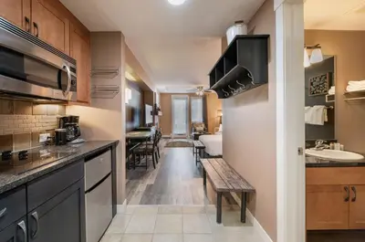 a kitchen with a bench and a sink in a room at Premium Unit 4371- Fraser Crossing Founders Pointe condo in Winter Park