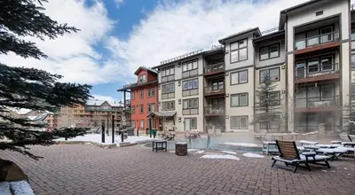 a courtyard with chairs and buildings in a city at Premium Unit 4371- Fraser Crossing Founders Pointe condo in Winter Park