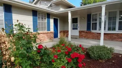 a house with red flowers in front of it at Broomfield Home in Broomfield