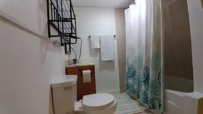 a white bathroom with a toilet and a shower at Broomfield Home in Broomfield