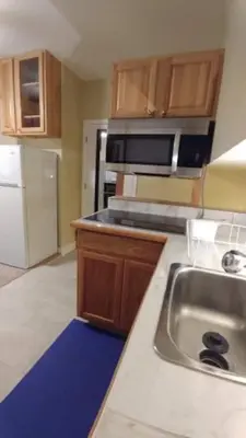 a kitchen with a sink and a refrigerator at Broomfield Home in Broomfield