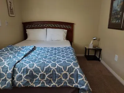 a bedroom with a bed with a blue and white comforter at Broomfield Home in Broomfield