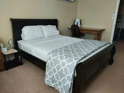 a bedroom with a large bed with a white comforter at Broomfield Home in Broomfield