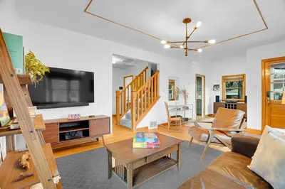 a living room with a couch and a tv at Beautiful Historic House in Central Longmont in Longmont