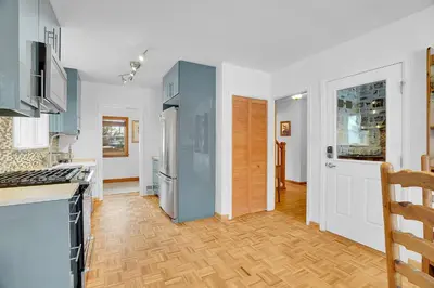 a kitchen with stainless steel appliances and wooden floors at Beautiful Historic House in Central Longmont in Longmont