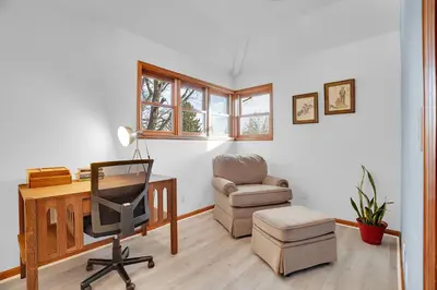 a living room with a desk and a chair and a computer at Beautiful Historic House in Central Longmont in Longmont
