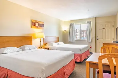 a hotel room with two beds and a table at City Inn in Westminster
