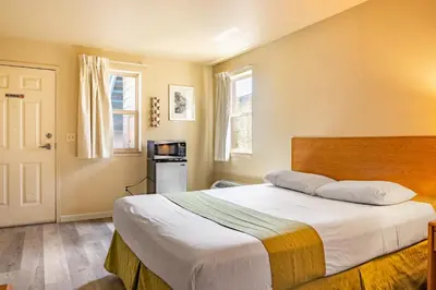 a bedroom with a large bed with white sheets at City Inn in Westminster