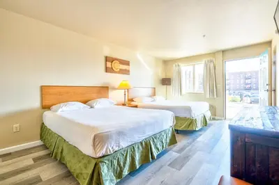 a hotel room with two beds and a window at City Inn in Westminster