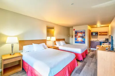 a hotel room with two beds and a kitchen at City Inn in Westminster