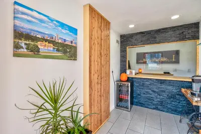 a kitchen with a counter and a blue brick wall at City Inn in Westminster