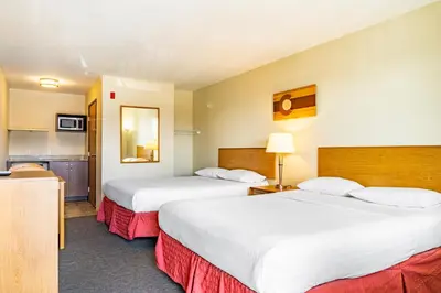 a hotel room with two beds and a kitchen at City Inn in Westminster