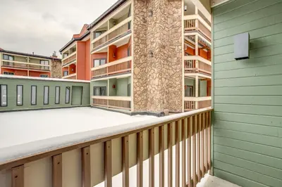 an apartment balcony with green and orange buildings at Easy Ski Shuttle Access! Winter Park Mtn Getaway in Winter Park