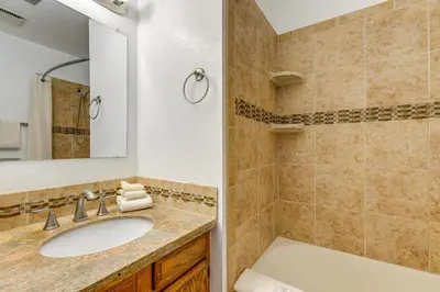 a bathroom with a sink and a mirror and a tub at Easy Ski Shuttle Access! Winter Park Mtn Getaway in Winter Park