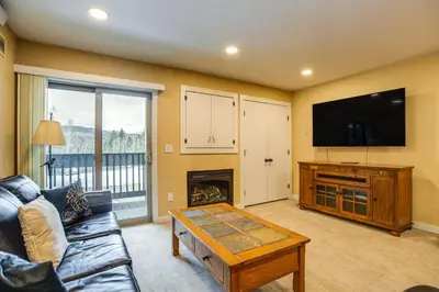 a living room with a couch and a tv and a fireplace at Easy Ski Shuttle Access! Winter Park Mtn Getaway in Winter Park