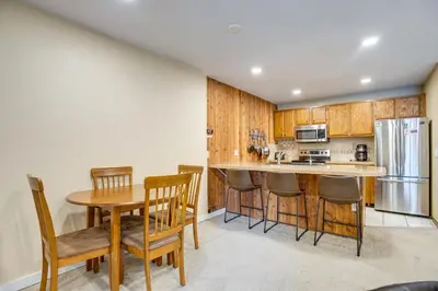 a kitchen with a table and chairs and a refrigerator at Easy Ski Shuttle Access! Winter Park Mtn Getaway in Winter Park