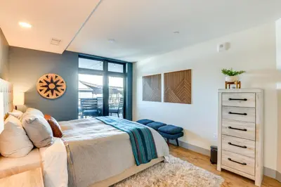 a bedroom with a bed and a dresser at Downtown Winter Park Condo 3 Mi to Slopes! in Winter Park