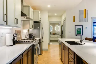 a kitchen with white counter tops and a sink at Downtown Winter Park Condo 3 Mi to Slopes! in Winter Park