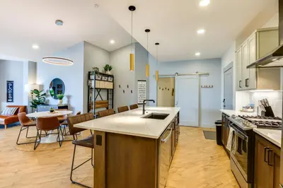 an open kitchen and dining room with a table and chairs at Downtown Winter Park Condo 3 Mi to Slopes! in Winter Park