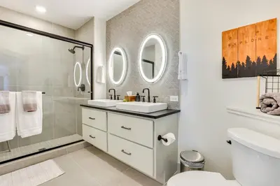 a bathroom with two sinks and a shower at Downtown Winter Park Condo 3 Mi to Slopes! in Winter Park