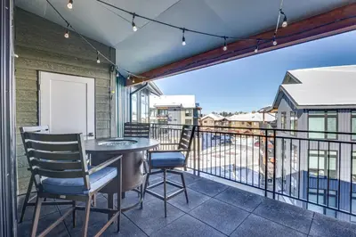 a balcony with a table and chairs and a view at Downtown Winter Park Condo 3 Mi to Slopes! in Winter Park