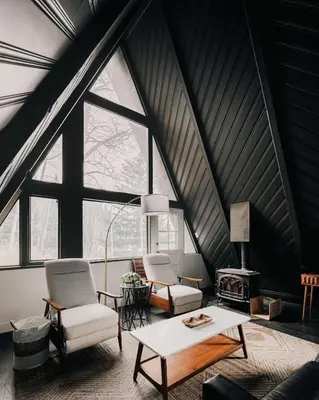 a living room with two chairs and a table at Modern A-Frame - Mountain Views - Evergreen in Evergreen