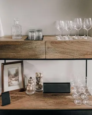 two pictures of wine glasses on a wooden shelf at Modern A-Frame - Mountain Views - Evergreen in Evergreen