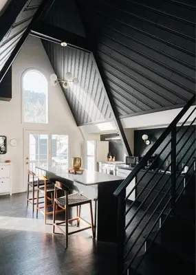 an attic kitchen with a long table and chairs at Modern A-Frame - Mountain Views - Evergreen in Evergreen
