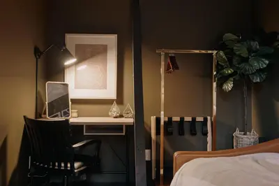 a bedroom with a desk and a chair next to a bed at Modern A-Frame - Mountain Views - Evergreen in Evergreen
