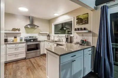 a kitchen with white cabinets and a counter top at Cozy Mountain Home with Great Views, Deck & WiFi in Lyons