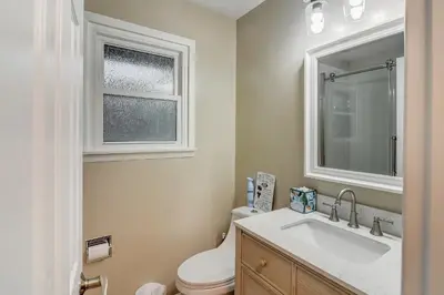 a bathroom with a toilet and a sink and a window at Cozy Mountain Home with Great Views, Deck & WiFi in Lyons