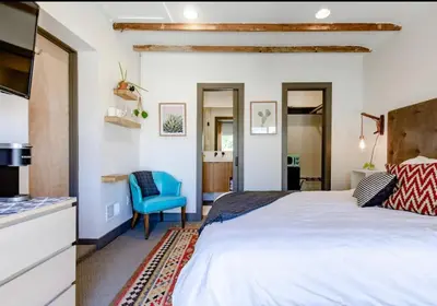 a bedroom with a large bed and a blue chair at Unique Denver Designer Home 3 Bed 3 Bath in Denver