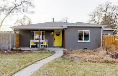 a gray house with a yellow door and a table at Unique Denver Designer Home 3 Bed 3 Bath in Denver