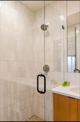a shower with a glass door next to a sink at Unique Denver Designer Home 3 Bed 3 Bath in Denver
