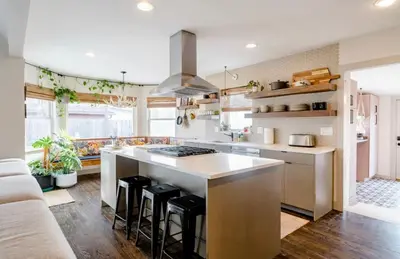 a kitchen with a large island with bar stools at Unique Denver Designer Home 3 Bed 3 Bath in Denver