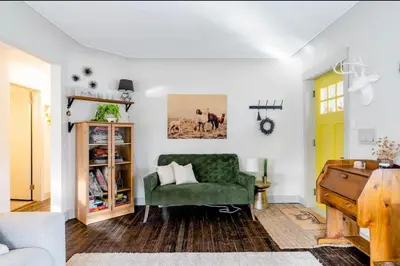 a living room with a green couch and a piano at Unique Denver Designer Home 3 Bed 3 Bath in Denver