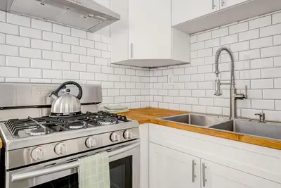 a kitchen with a stove and a sink at Stiles Historical Estate - 26th St in Denver